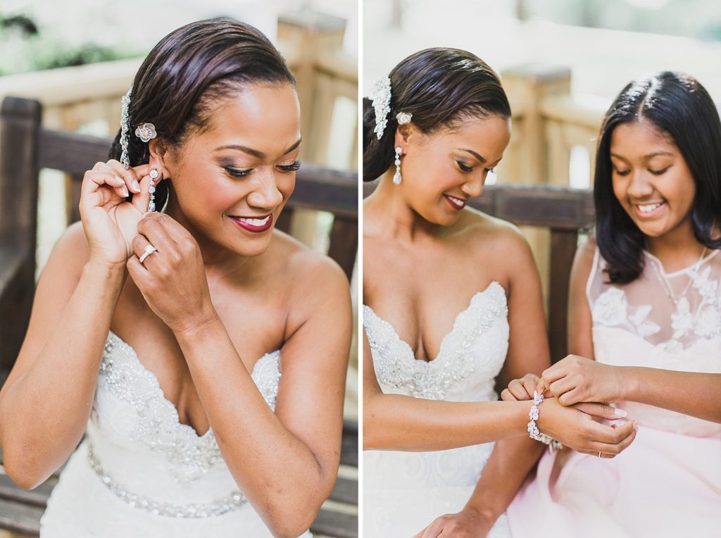 bride puts on jewelry before Airlie wedding