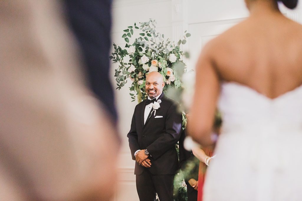 groom sees bride coming down aisle at Airlie wedding 