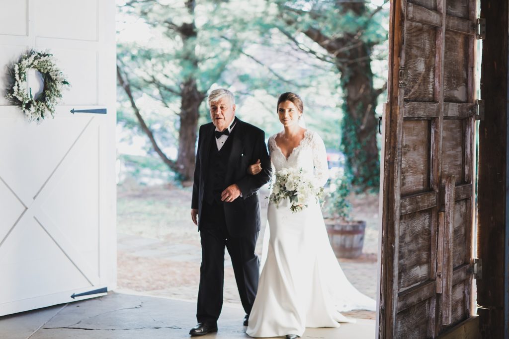 father and bride enter Inn at the Old Silk Mill wedding photographed by M Harris Studios
