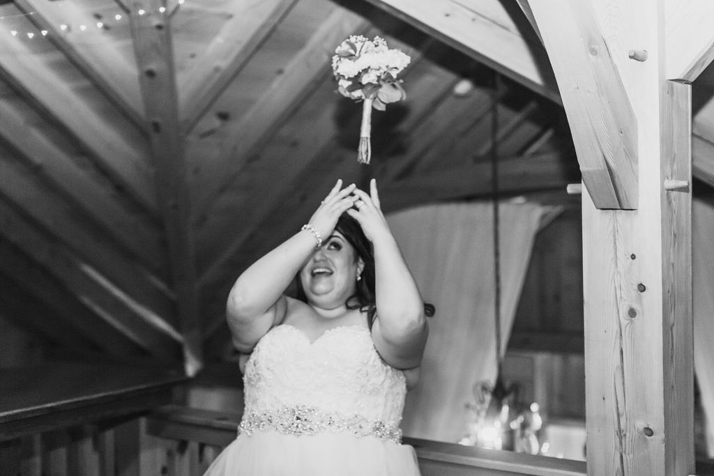 bouquet toss at reception photographed by M Harris Studios
