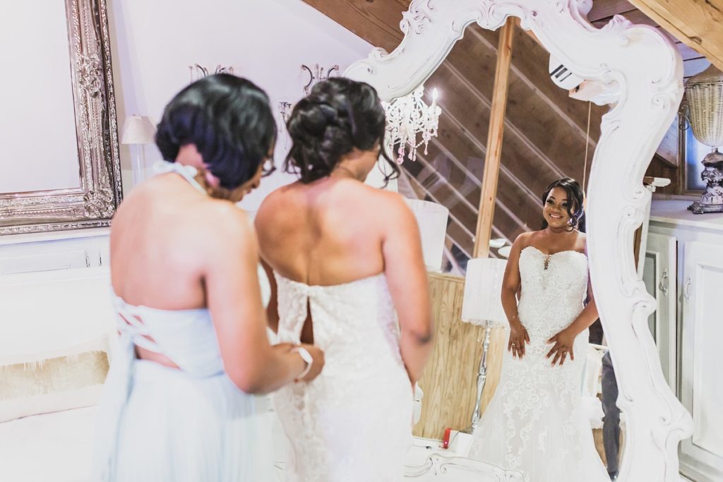 bride gets into wedding gown photographed by M Harris Studios